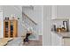 Entryway with stairs and decorative touches next to the kitchen, showcasing a charming school desk at 3624 N Lakeside Dr, Muncie, IN 47304
