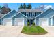 Charming townhome with light blue siding, white trim, attached garages, and a well-maintained lawn at 3624 N Lakeside Dr, Muncie, IN 47304