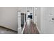Bright hallway with wood floors, access to a bedroom and a white door with brushed nickel hardware at 3624 N Lakeside Dr, Muncie, IN 47304