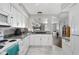 Bright kitchen with white cabinetry, granite countertops, and modern appliances, open to the living area at 3624 N Lakeside Dr, Muncie, IN 47304