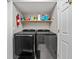 Laundry room with black Samsung washer and dryer and a full shelf above at 3624 N Lakeside Dr, Muncie, IN 47304