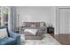Comfortable living room featuring a plush sofa, ottoman, and a stylish rug over wood-look flooring at 3624 N Lakeside Dr, Muncie, IN 47304
