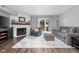 Inviting living room with a fireplace, comfortable seating, and a sliding door to the outside at 3624 N Lakeside Dr, Muncie, IN 47304