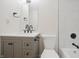 This remodeled bathroom has a gray vanity and a shower/tub combo with white, marble-look tile at 3648 Valley Lake Dr, Indianapolis, IN 46227