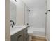 This remodeled bathroom has a gray vanity and a shower/tub combo with white, marble-look tile at 3648 Valley Lake Dr, Indianapolis, IN 46227