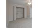 This empty bedroom has neutral walls and carpet and an open closet at 3648 Valley Lake Dr, Indianapolis, IN 46227