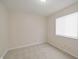 This empty bedroom has neutral walls and carpet and one window at 3648 Valley Lake Dr, Indianapolis, IN 46227