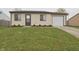 Charming single-story home featuring a well-manicured lawn and an attached garage at 3648 Valley Lake Dr, Indianapolis, IN 46227