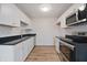 Modern kitchen featuring stainless steel appliances, stylish countertops, and hardwood floors at 3648 Valley Lake Dr, Indianapolis, IN 46227
