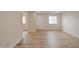 This living room has wood-look floors, light, neutral walls, and two windows with blinds at 3648 Valley Lake Dr, Indianapolis, IN 46227