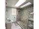 Bright bathroom featuring a skylight and tiled walk-in shower at 37 N Arlington Ave, Indianapolis, IN 46219