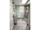 Updated bathroom featuring a skylight, modern vanity, and tiled walk-in shower at 37 N Arlington Ave, Indianapolis, IN 46219