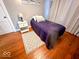 Bedroom featuring wood floors, a cozy bed with patterned pillows, and a stylish rug at 37 N Arlington Ave, Indianapolis, IN 46219