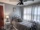 Calm bedroom with black ceiling fan, gray bedding, and windows with sheer curtains at 37 N Arlington Ave, Indianapolis, IN 46219