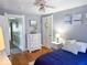 Cozy bedroom with hardwood floors, white dresser, and comfortable blue bedding at 37 N Arlington Ave, Indianapolis, IN 46219
