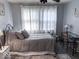 Bedroom with decorative metal bedframe, windows, and desk setup at 37 N Arlington Ave, Indianapolis, IN 46219