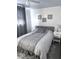 Neutral bedroom with white walls, curtains, a cozy bed, and a nightstand with a lamp at 37 N Arlington Ave, Indianapolis, IN 46219