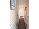 Hallway features neutral paint, a patterned runner rug, and multiple doors at 37 N Arlington Ave, Indianapolis, IN 46219