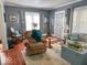 Cozy living room with wood floors, rug, recliner and an abundance of natural light at 37 N Arlington Ave, Indianapolis, IN 46219