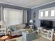Inviting living room features cozy seating, natural light and hardwood floors at 37 N Arlington Ave, Indianapolis, IN 46219