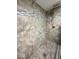 Detail of the stone tiled shower with decorative accents and modern fixtures at 37 N Arlington Ave, Indianapolis, IN 46219