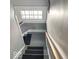 Gray and white staircase with natural light, and dark gray carpet treads at 37 N Arlington Ave, Indianapolis, IN 46219