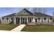 Beautiful ranch-style home with gray siding, stone accents, a covered porch, and manicured landscaping at 3767 Thomas Jefferson Ct, Westfield, IN 46074