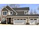 A craftsman style home with a two car garage, stone accents, and neutral toned horizontal and shake siding at 3818 Thomas Jefferson Ct, Westfield, IN 46074