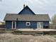 This backyard features a deck, blue siding and a grassy yard at 389 W Poston Rd, Martinsville, IN 46151