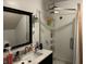 Well-lit bathroom featuring a glass-enclosed shower and a modern sink with a black framed mirror at 389 W Poston Rd, Martinsville, IN 46151