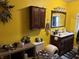 Bathroom showcasing yellow walls and dark wood cabinets with a stylish sink and vanity at 389 W Poston Rd, Martinsville, IN 46151