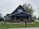 Charming home featuring a covered porch with brick supports and a prominent star decoration at 389 W Poston Rd, Martinsville, IN 46151