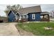 This home features blue siding, a brick porch, and a well-maintained lawn at 389 W Poston Rd, Martinsville, IN 46151