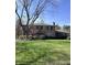 Charming two-story brick home with a manicured lawn and mature landscaping creating great curb appeal at 3911 E 75Th St, Indianapolis, IN 46240