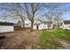 Spacious backyard featuring an old white home with a covered porch and storage shed at 419 S Oak St, Fortville, IN 46040