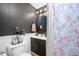 Stylish half bathroom featuring dark walls, a modern mirror, and a floral shower curtain at 419 S Oak St, Fortville, IN 46040