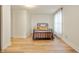 Bright bedroom featuring wood floors, neutral walls, and a metal frame bed at 419 S Oak St, Fortville, IN 46040