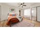 Cozy bedroom with a metal frame bed, ceiling fan, and a large rug at 419 S Oak St, Fortville, IN 46040