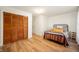 Bedroom with hardwood floors, closet doors, and natural light at 419 S Oak St, Fortville, IN 46040