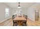 Elegant dining room with ample seating, hardwood floors, and a view into other rooms at 419 S Oak St, Fortville, IN 46040