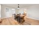 Warm dining room featuring a rustic wood table, stylish seating, and lovely hardwood floors at 419 S Oak St, Fortville, IN 46040