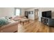 Cozy living room with wood flooring, comfortable sofas, and a view into adjoining rooms at 419 S Oak St, Fortville, IN 46040