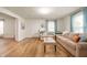 Bright and airy living room featuring wood floors, neutral walls, and comfortable seating at 419 S Oak St, Fortville, IN 46040