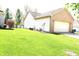 Well-maintained backyard featuring a pristine lawn, an attached two-car garage and a brick exterior at 45 Golden Tree Ln, Indianapolis, IN 46227