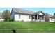 A backyard with a screened-in porch and green lawn surrounded by a black chain link fence at 45 Golden Tree Ln, Indianapolis, IN 46227