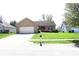Lovely single-story brick home with an attached two-car garage and mature landscaping in the front yard at 45 Golden Tree Ln, Indianapolis, IN 46227