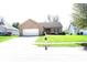 Well maintained single-story brick home with a manicured lawn and an attached two-car garage at 45 Golden Tree Ln, Indianapolis, IN 46227