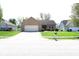 Beautiful single-story brick home with a well-maintained lawn and an attached two-car garage at 45 Golden Tree Ln, Indianapolis, IN 46227