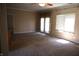 Spacious living room with carpet, ceiling fan, and natural light, leading to a patio door at 45 Golden Tree Ln, Indianapolis, IN 46227