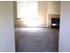 Cozy living room featuring neutral carpet, ample natural light, and a charming fireplace at 45 Golden Tree Ln, Indianapolis, IN 46227